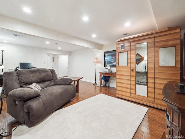 living room featuring recessed lighting, visible vents, baseboards, and wood finished floors