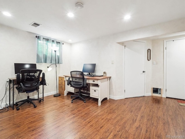 home office featuring baseboards, wood finished floors, visible vents, and recessed lighting