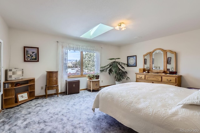 carpeted bedroom featuring a skylight and baseboards