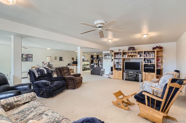 carpeted living room with a ceiling fan and a textured ceiling