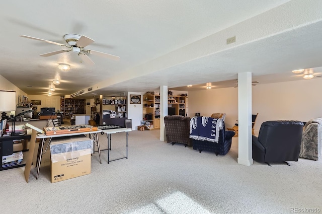 finished basement with carpet flooring and a ceiling fan