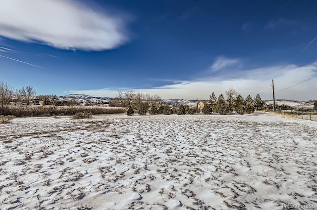 snowy yard featuring a mountain view