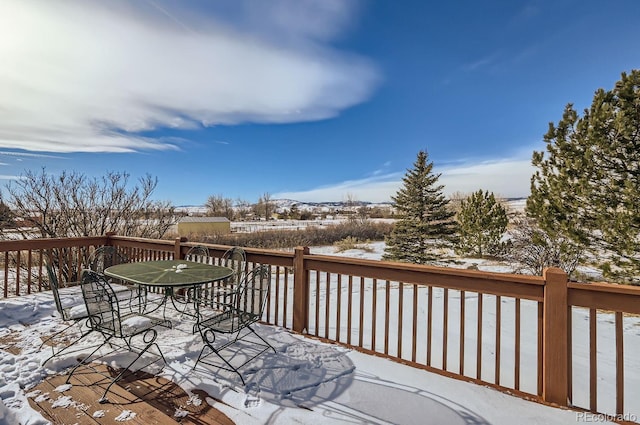 snow covered deck with outdoor dining space