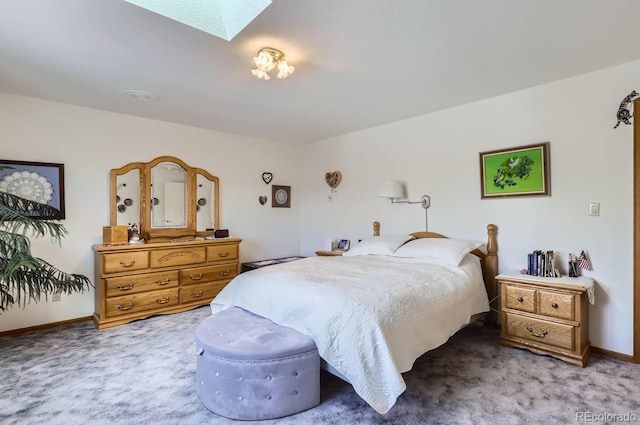 bedroom with a skylight, baseboards, and carpet floors