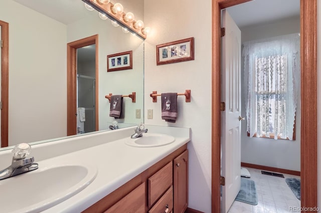 full bath with a shower with shower door, double vanity, visible vents, and a sink