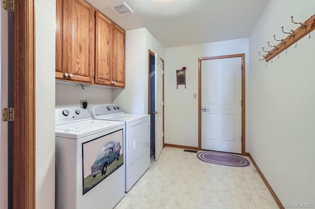washroom with baseboards, washing machine and dryer, visible vents, cabinet space, and light floors