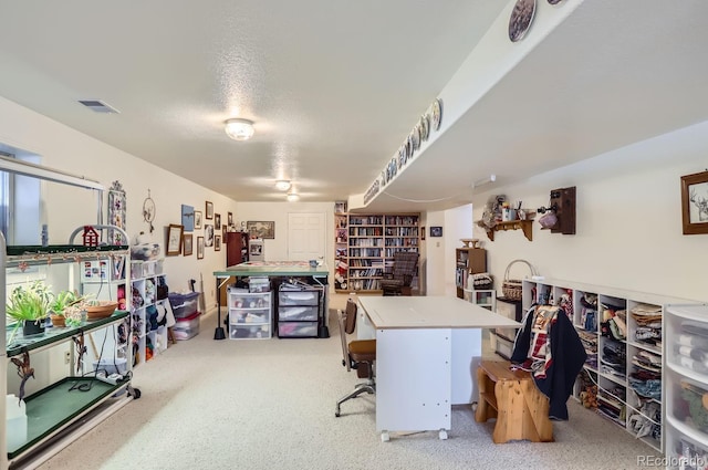 carpeted office space with visible vents and a textured ceiling