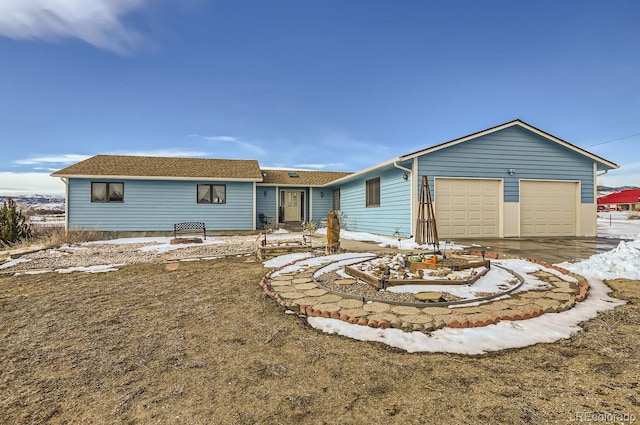 view of front of home with an attached garage, a shingled roof, and driveway