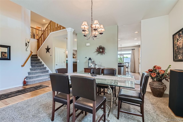 13962 Dexter Way, Thornton, CO 80602 - dining room with a chandelier, stairs, wood finished floors, recessed lighting, and ornate columns