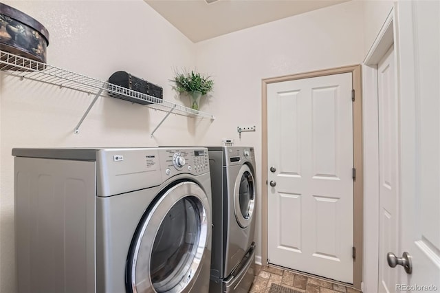 13962 Dexter Way, Thornton, CO 80602 - laundry area featuring washing machine and dryer and stone finish floors