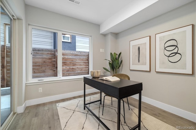 office with light wood-type flooring