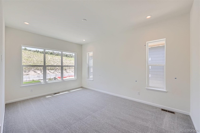 unfurnished room with light colored carpet