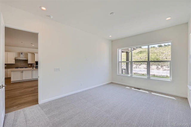 spare room with light colored carpet