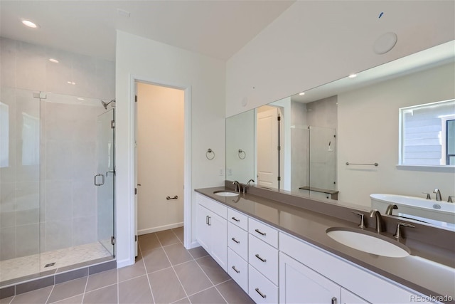 bathroom featuring vanity, tile patterned floors, and walk in shower