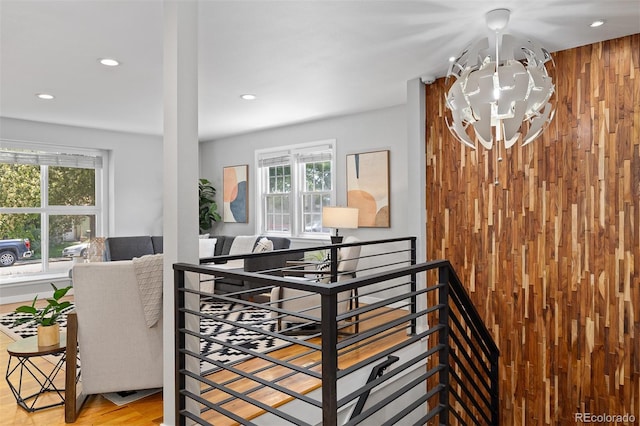 4451 Eliot St, Denver, CO 80211 - stairs featuring plenty of natural light, wooden walls, a chandelier, and recessed lighting