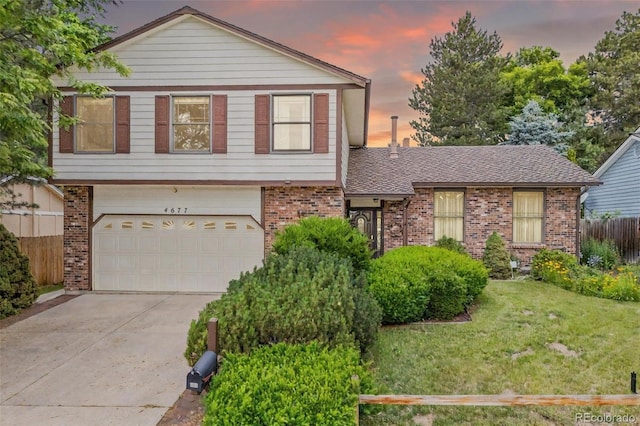 4677 S Wolff St, Denver, CO 80236 - split level home with brick siding, a garage, and concrete driveway