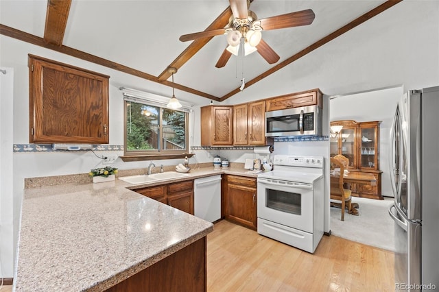 4677 S Wolff St, Denver, CO 80236 - kitchen featuring stainless steel appliances, vaulted ceiling, a ceiling fan, brown cabinets, and light wood-style flooring