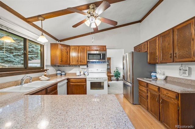 4677 S Wolff St, Denver, CO 80236 - kitchen featuring appliances with stainless steel finishes, vaulted ceiling, ceiling fan, ornamental molding, and brown cabinetry