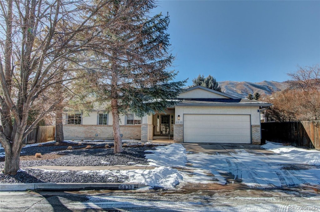 view of front of home with a garage and a mountain view