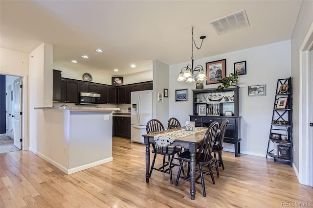 8445 S Holland Way Unit 205, Littleton, CO 80128 - dining area with a chandelier, light wood-style floors, recessed lighting, and baseboards