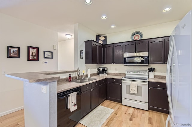 8445 S Holland Way Unit 205, Littleton, CO 80128 - kitchen with white appliances, a sink, light wood finished floors, a peninsula, and recessed lighting