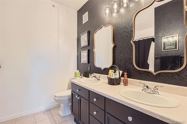 8445 S Holland Way Unit 205, Littleton, CO 80128 - bathroom featuring tile patterned floors, toilet, double vanity, and baseboards