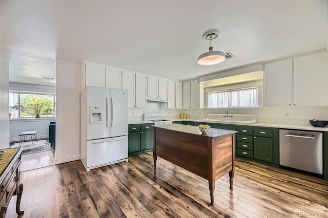 947 S Yates St, Denver, CO 80219 - kitchen featuring white refrigerator with ice dispenser, green cabinetry, stainless steel dishwasher, and range