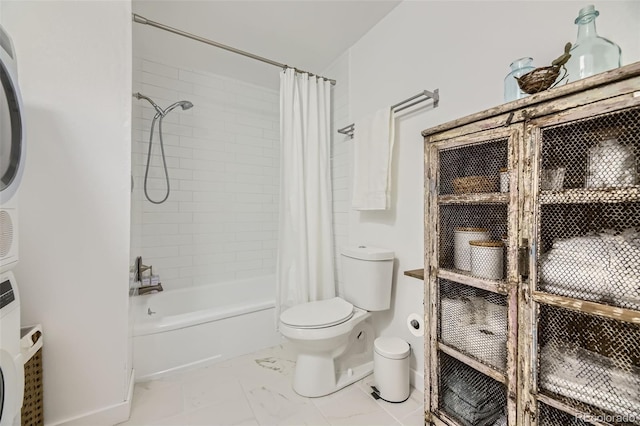 947 S Yates St, Denver, CO 80219 - full bathroom with stacked washer / dryer, toilet, shower / bath combo, marble finish floors, and baseboards