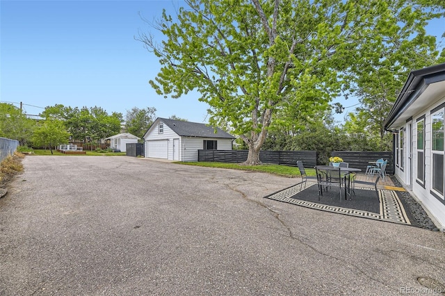 947 S Yates St, Denver, CO 80219 - view of patio / terrace with a garage, an outbuilding, and outdoor dining space