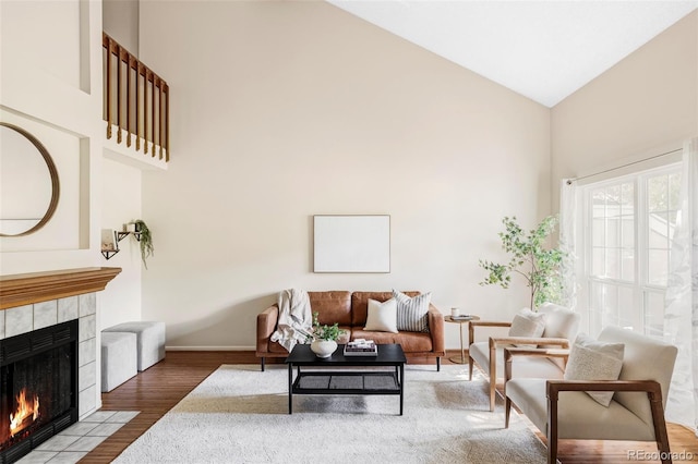 923 S Fairplay St, Aurora, CO 80012 - living area featuring high vaulted ceiling, a fireplace, and wood finished floors