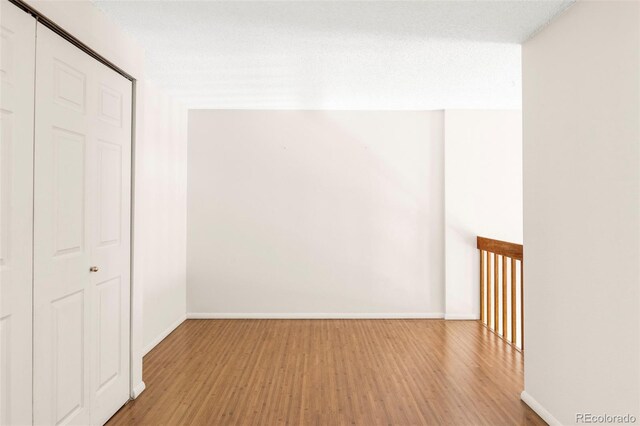 923 S Fairplay St, Aurora, CO 80012 - unfurnished bedroom featuring wood finished floors and baseboards