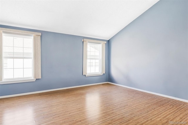 923 S Fairplay St, Aurora, CO 80012 - empty room featuring wood finished floors and vaulted ceiling