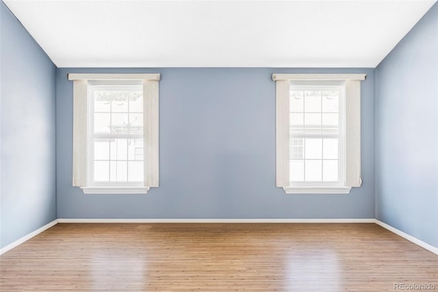 923 S Fairplay St, Aurora, CO 80012 - unfurnished room featuring wood finished floors and plenty of natural light