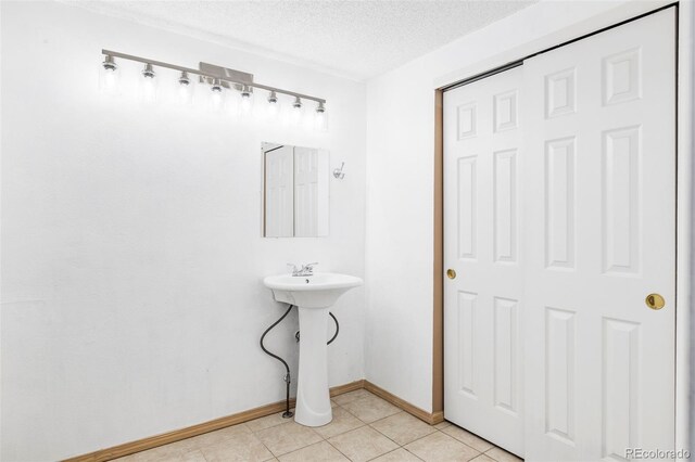 923 S Fairplay St, Aurora, CO 80012 - bathroom with a textured ceiling and tile patterned flooring