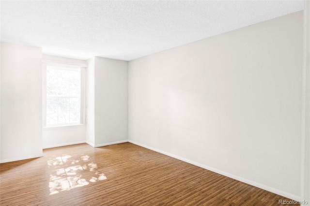 923 S Fairplay St, Aurora, CO 80012 - empty room with baseboards and wood finished floors
