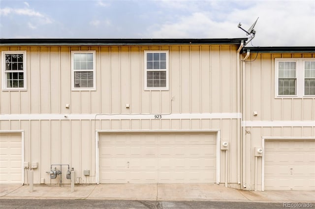 923 S Fairplay St, Aurora, CO 80012 - back of house featuring board and batten siding and a garage