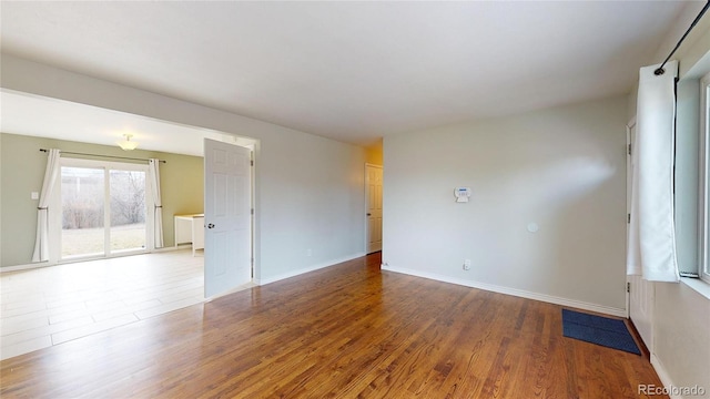 unfurnished room with hardwood / wood-style flooring