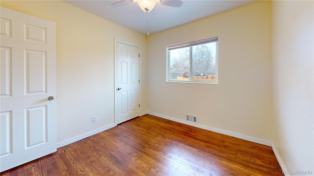 unfurnished bedroom with ceiling fan and dark hardwood / wood-style flooring