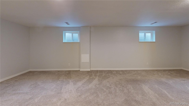 basement featuring light carpet