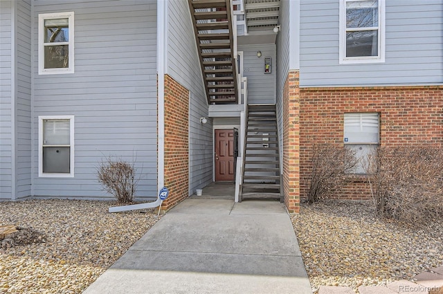 view of exterior entry with brick siding