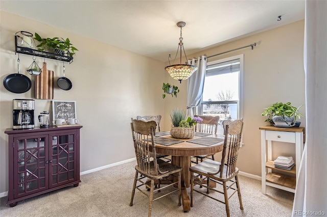 dining room featuring carpet and baseboards