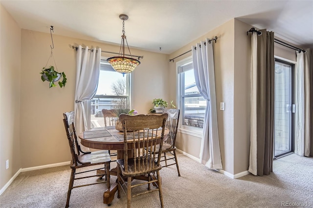 dining area with carpet flooring and baseboards