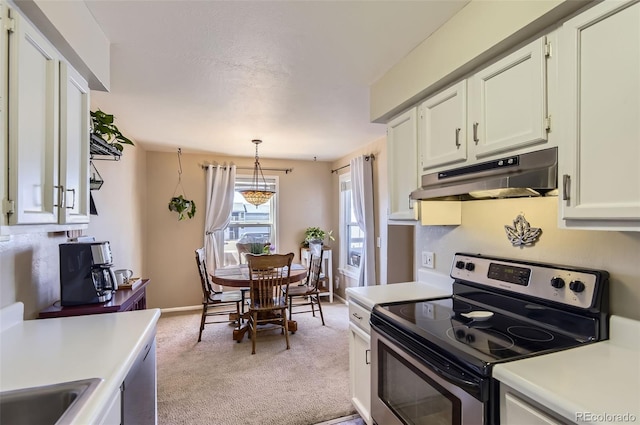 kitchen with under cabinet range hood, light countertops, light carpet, electric range, and white cabinets