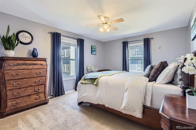 bedroom with multiple windows, a ceiling fan, baseboards, and carpet floors