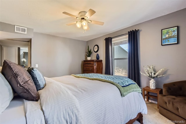 carpeted bedroom with visible vents and a ceiling fan