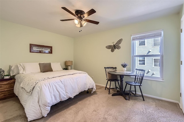 carpeted bedroom featuring a ceiling fan and baseboards