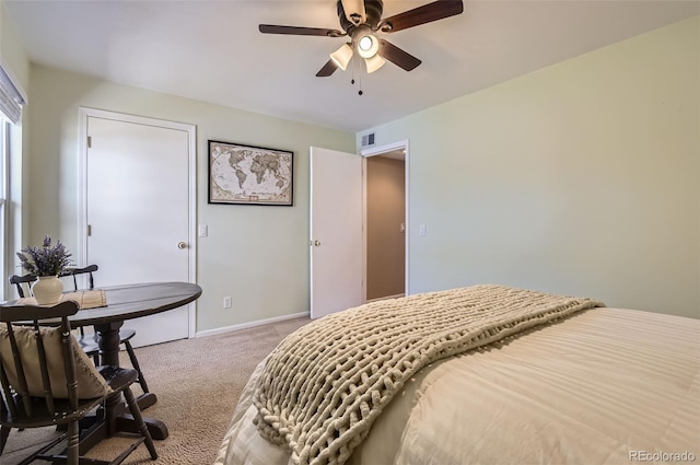 carpeted bedroom with visible vents, baseboards, and ceiling fan