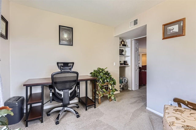 carpeted office space featuring visible vents and baseboards