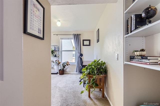 corridor with carpet and baseboards