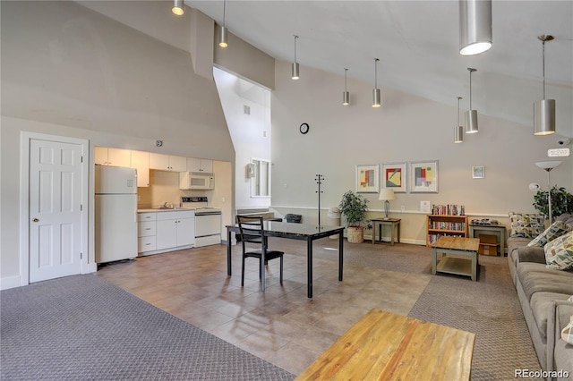 living room with visible vents, light carpet, and high vaulted ceiling